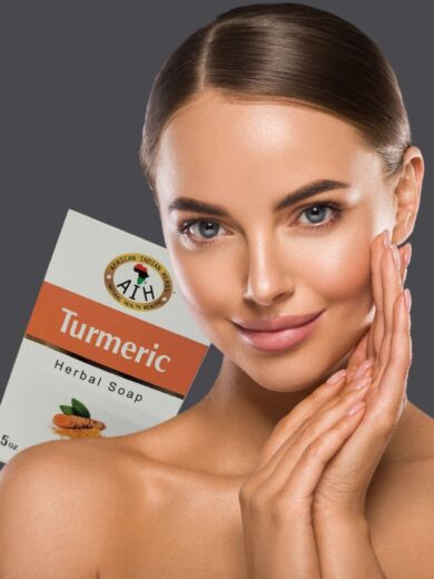 a close shot of a beautyful face women with glowing skin smiling,turmericsoap pack is peeking from her shoulder.